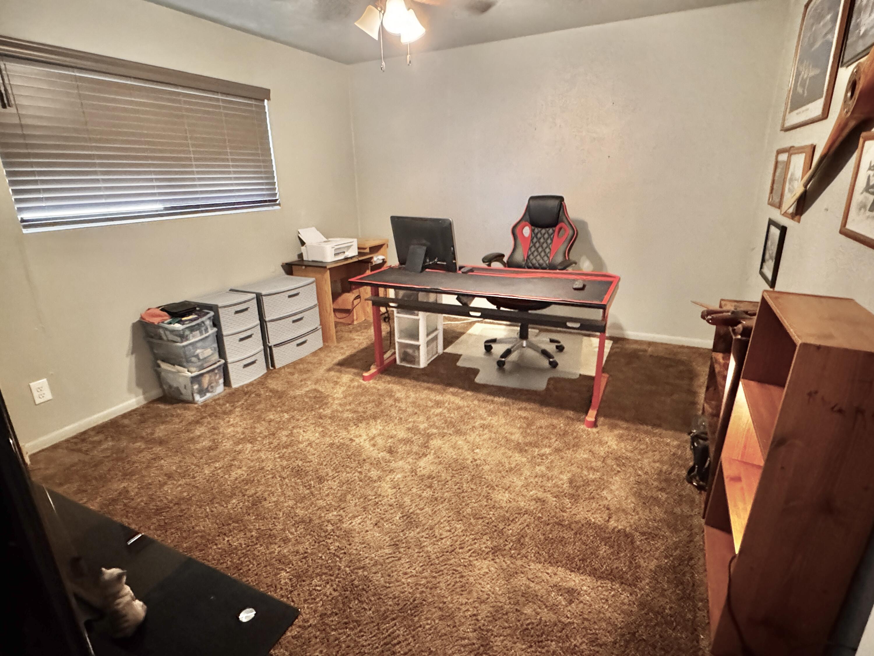 1720 Canyon Plainview, TX 79072 - Photo 28 of 49 a bedroom with a bed and wooden floor