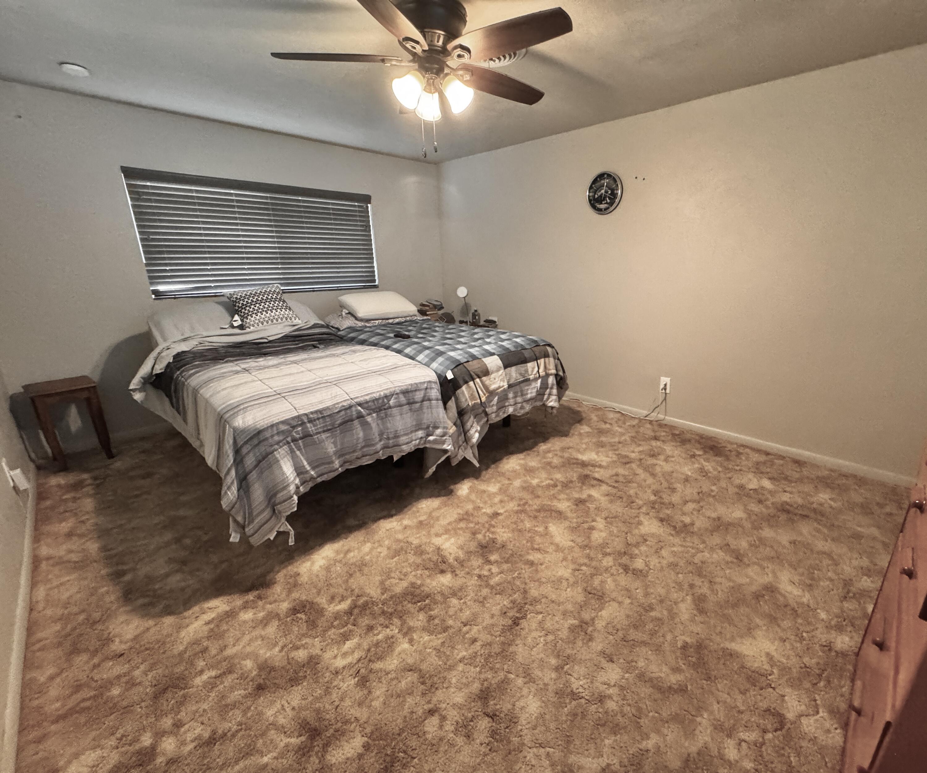 1720 Canyon Plainview, TX 79072 - Photo 30 of 49 a bedroom with a bed and a ceiling fan