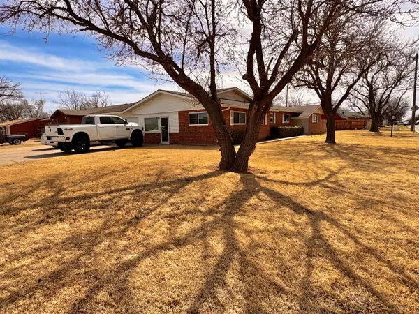 a front view of a house with a yard covered in snow