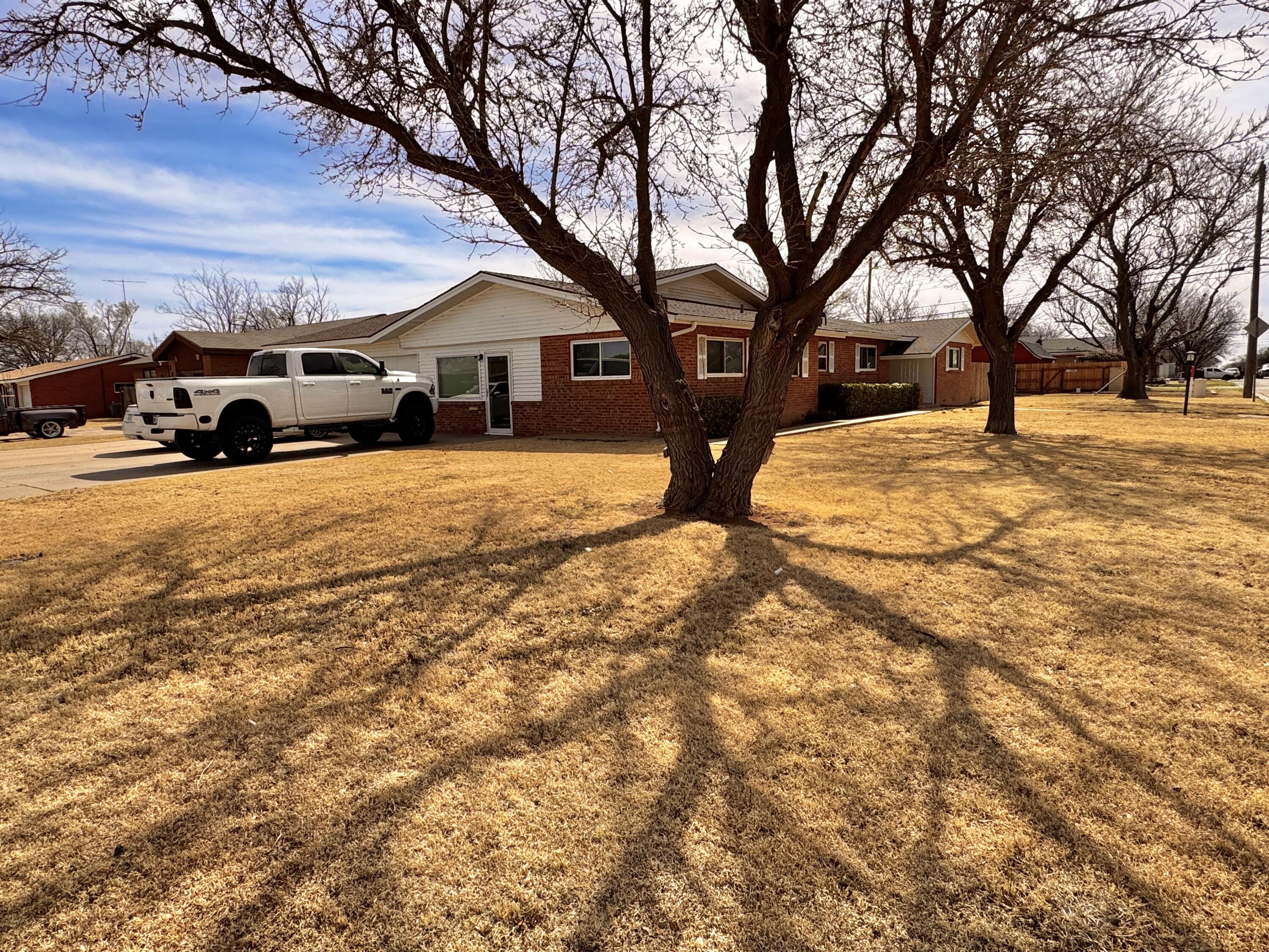 1720 Canyon Plainview, TX 79072 - Photo 3 of 49 a front view of a house with a yard covered in snow