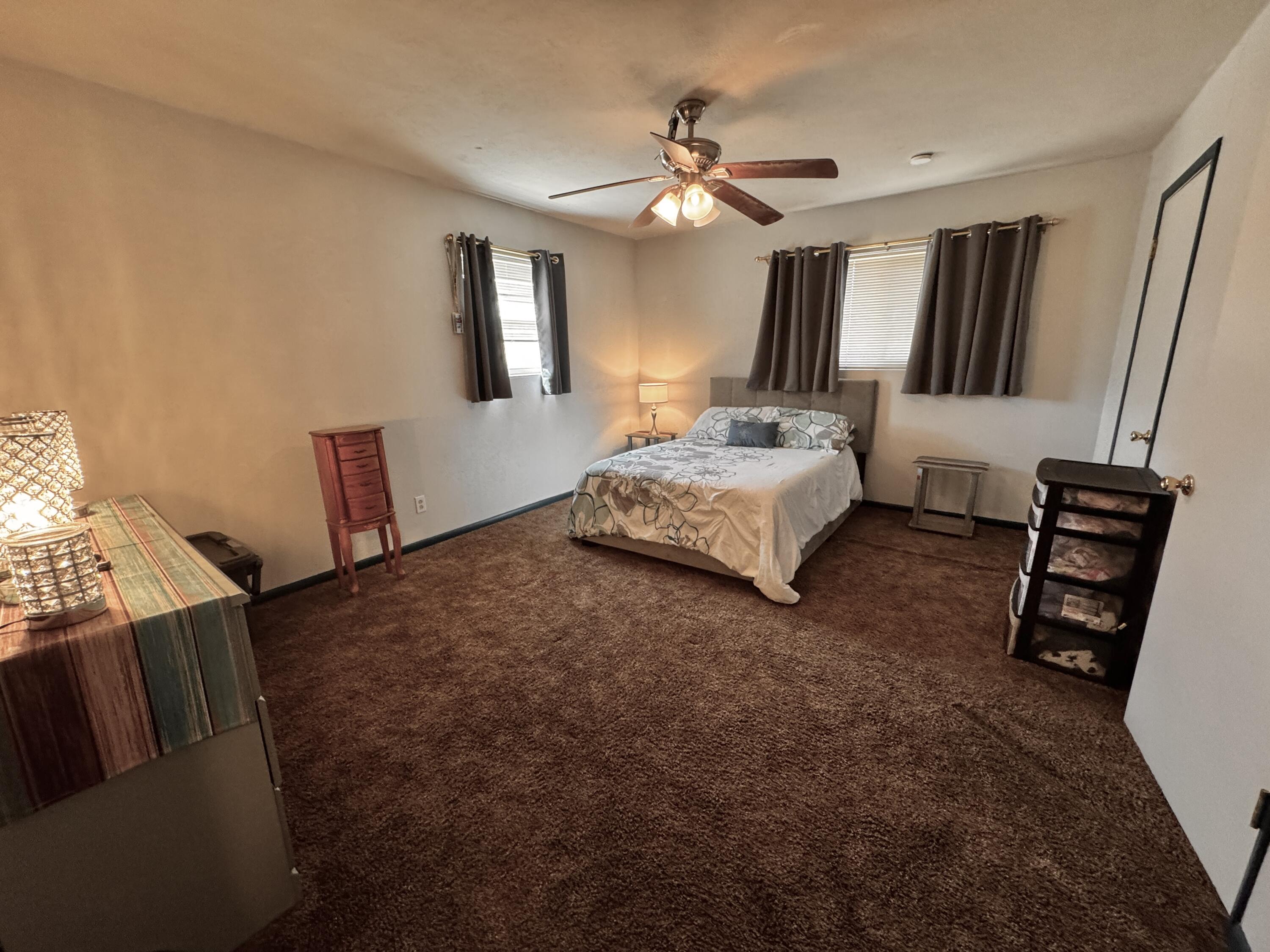 1720 Canyon Plainview, TX 79072 - Photo 35 of 49 a spacious bedroom with a bed and a dresser in it