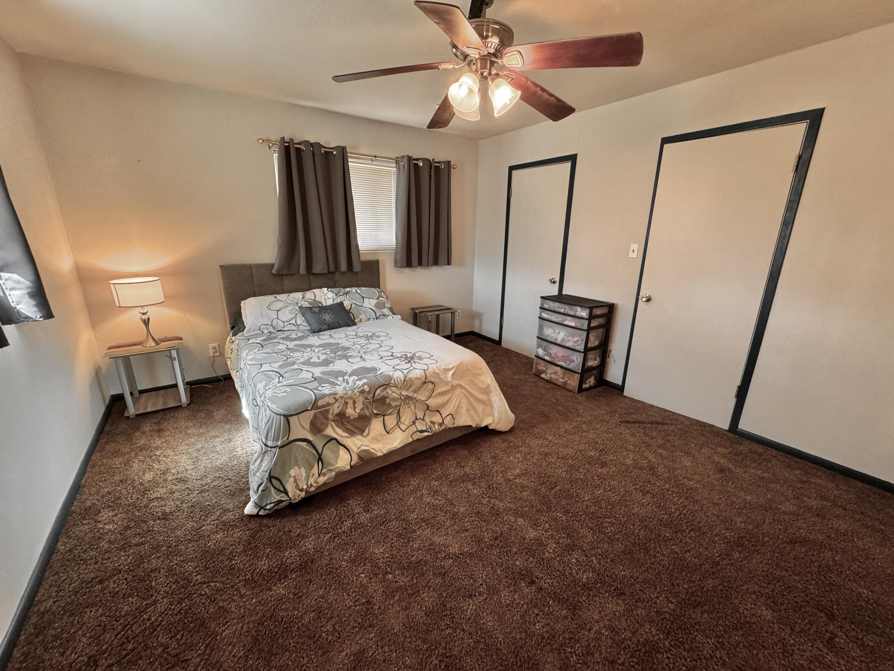 1720 Canyon Plainview, TX 79072 - Photo 37 of 49 a bedroom with a bed and a mirror