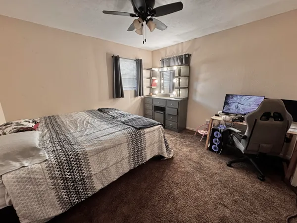 a bedroom with bed and window