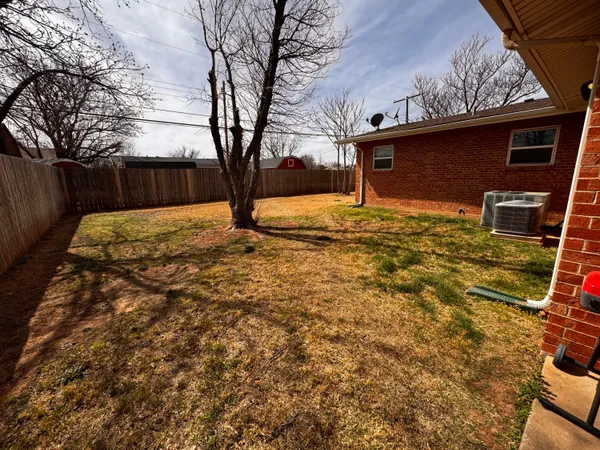 a view of a backyard of the house