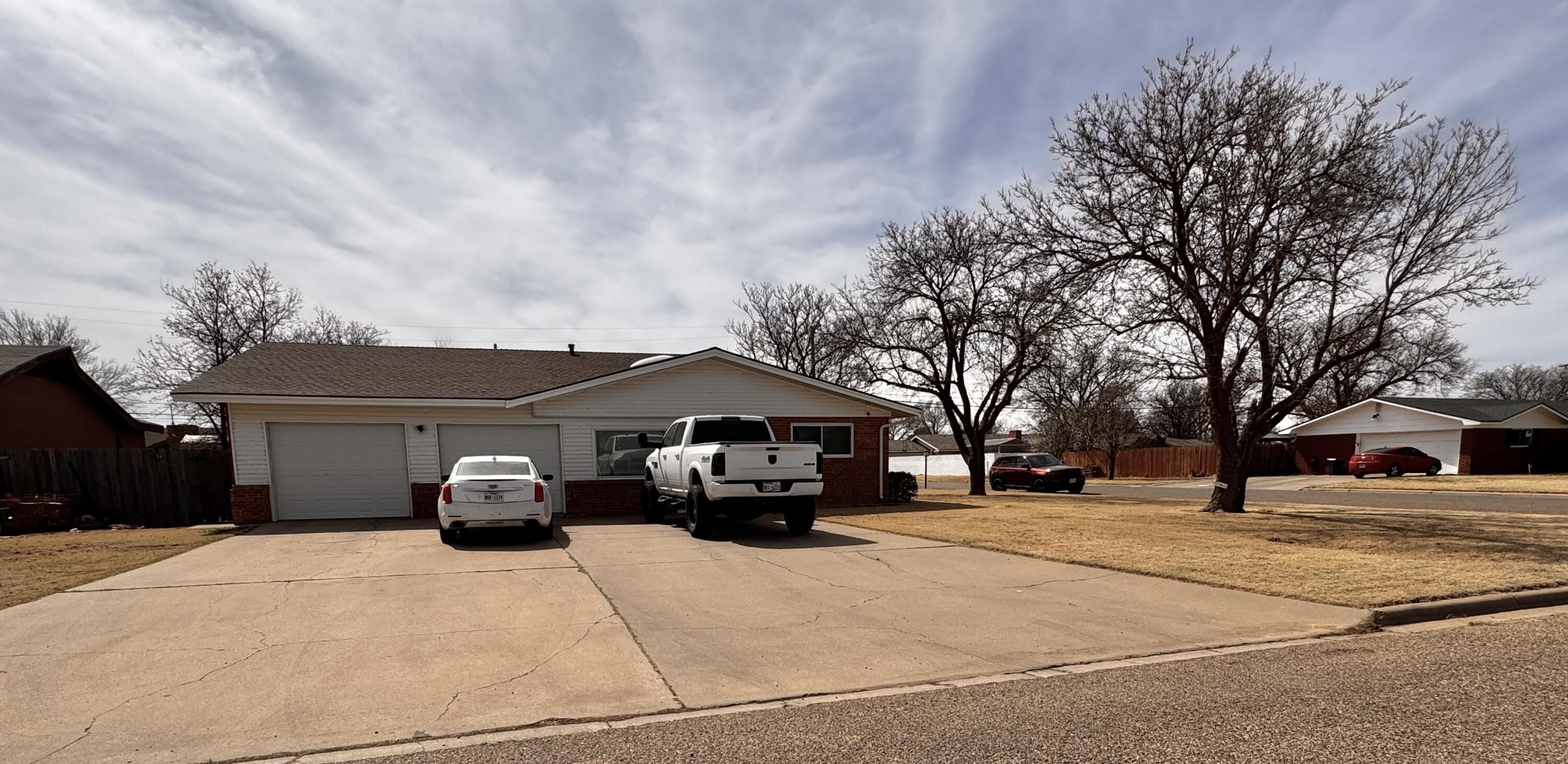 1720 Canyon Plainview, TX 79072 - Photo 5 of 49 a car parked in front of white house