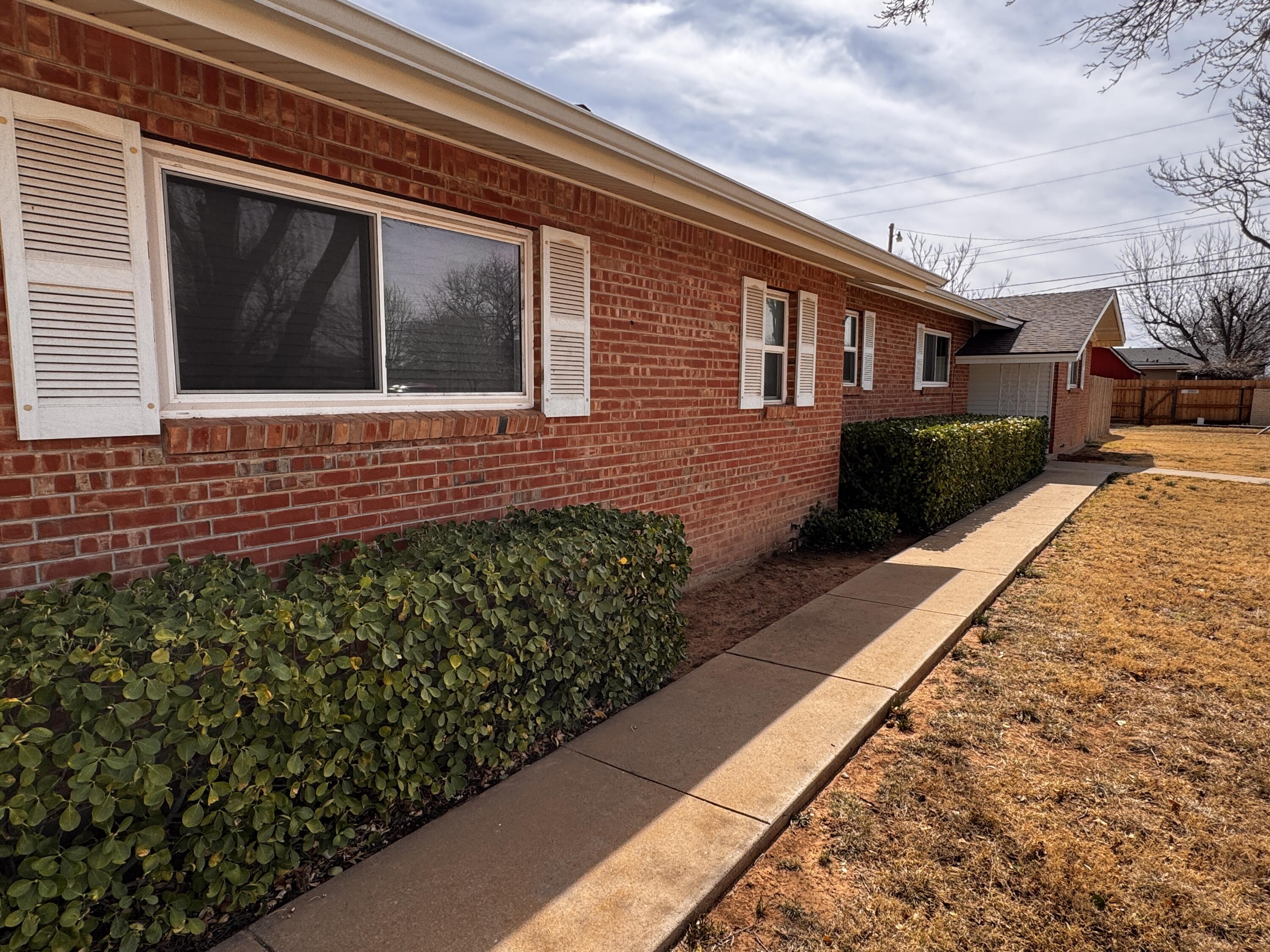 1720 Canyon Plainview, TX 79072 - Photo 6 of 49 a front view of a house with a yard