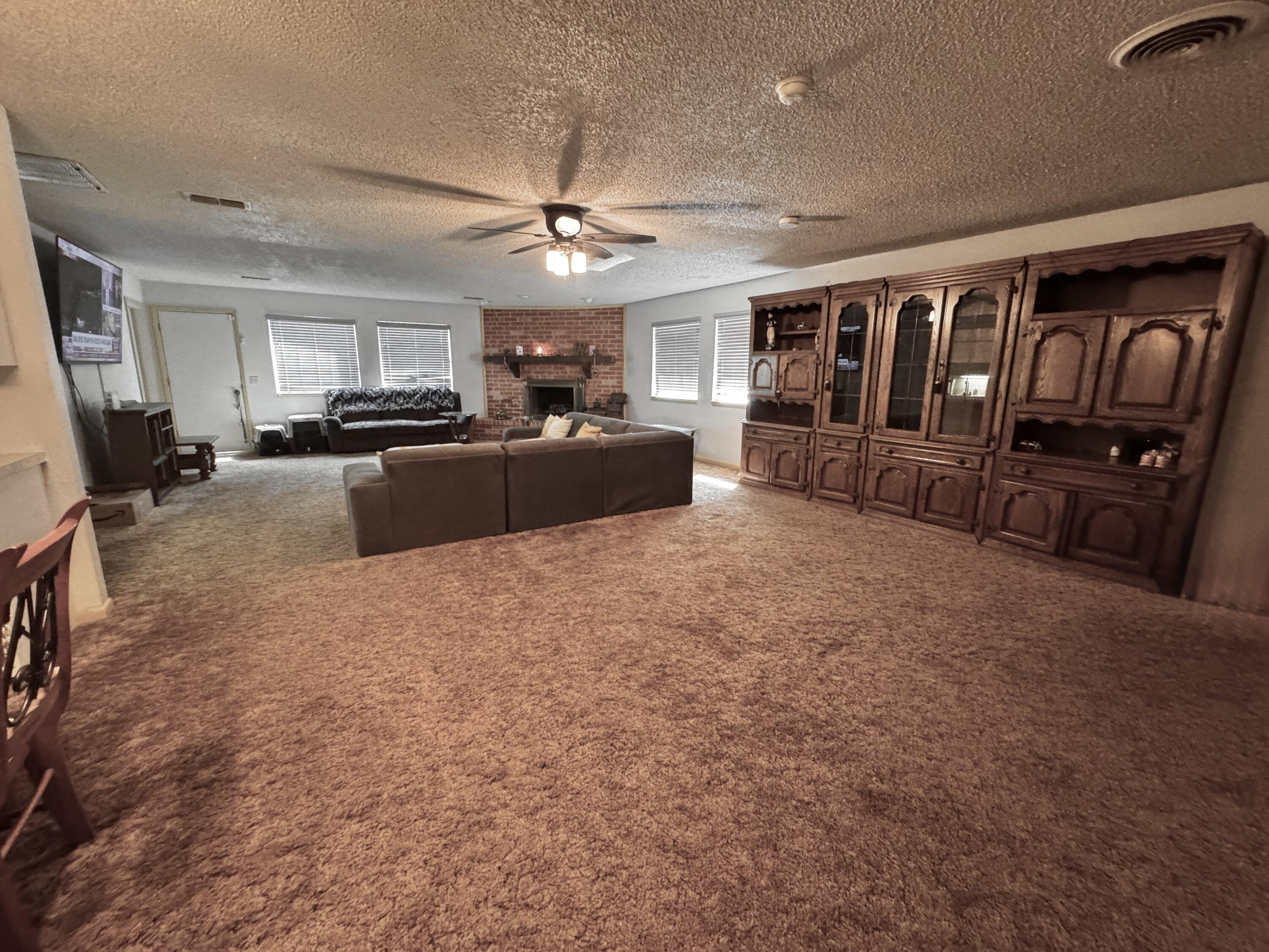 1720 Canyon Plainview, TX 79072 - Photo 10 of 49 a living room with furniture and a flat screen tv