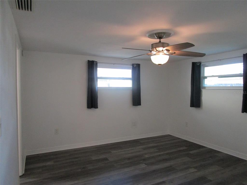 7226 San Moritz Drive Port Richey, FL 34668 - Photo 11 of 38 a view of an empty room with wooden floor and a window
