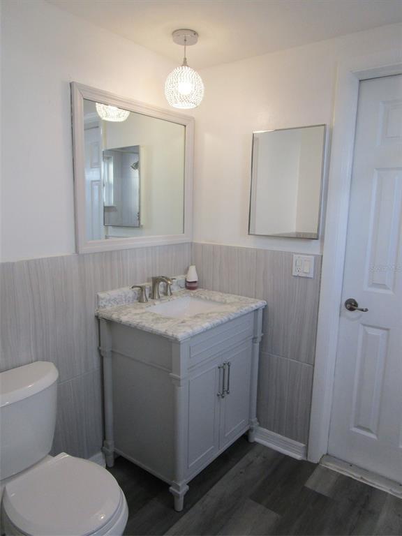 7226 San Moritz Drive Port Richey, FL 34668 - Photo 12 of 38 a bathroom with a granite countertop sink toilet and shower