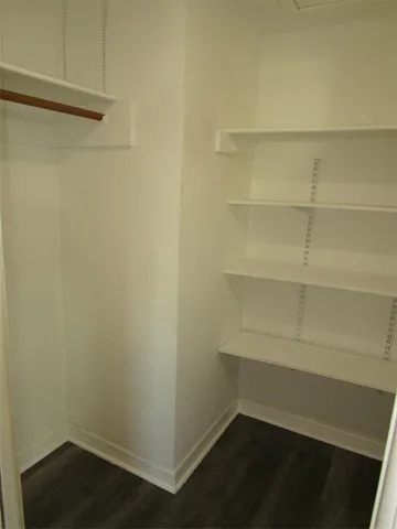 a empty closet with wooden floor