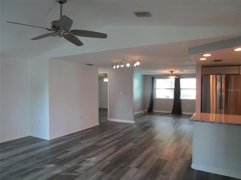 7226 San Moritz Drive Port Richey, FL 34668 - Photo 20 of 38 a view of an empty room with wooden floor and a window