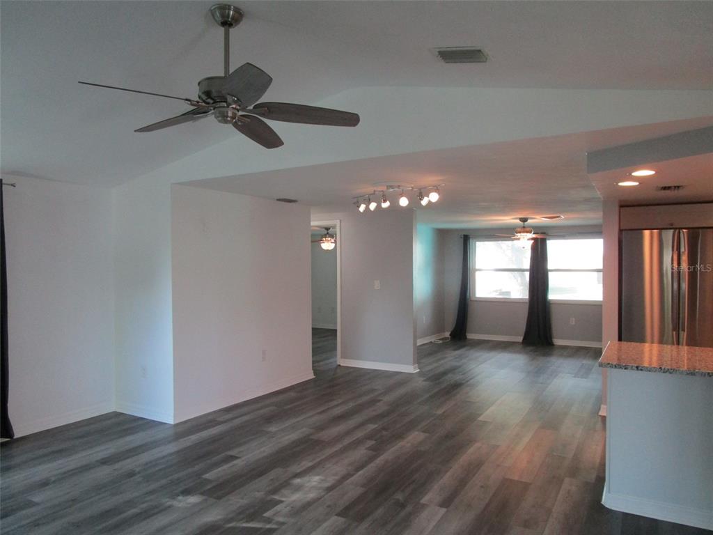 7226 San Moritz Drive Port Richey, FL 34668 - Photo 21 of 38 a view of an empty room with wooden floor and a window
