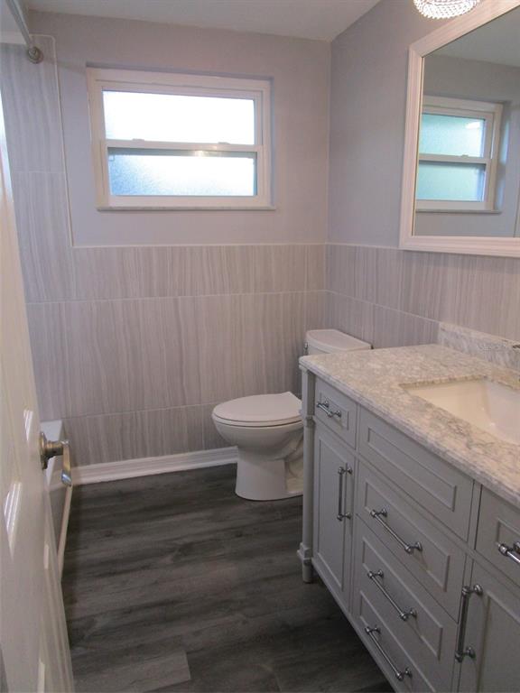 7226 San Moritz Drive Port Richey, FL 34668 - Photo 26 of 38 a bathroom with a granite countertop toilet and a sink