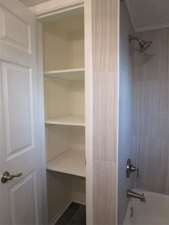 7226 San Moritz Drive Port Richey, FL 34668 - Photo 28 of 38 a bathroom with a glass shower door