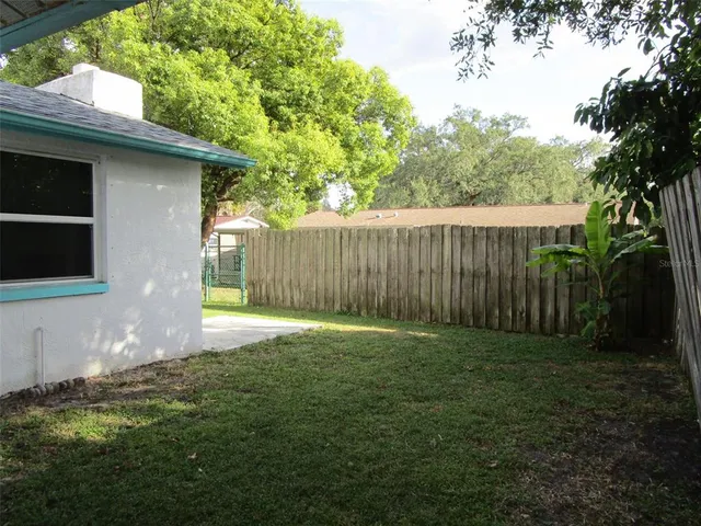 a backyard of a house with lots of green space