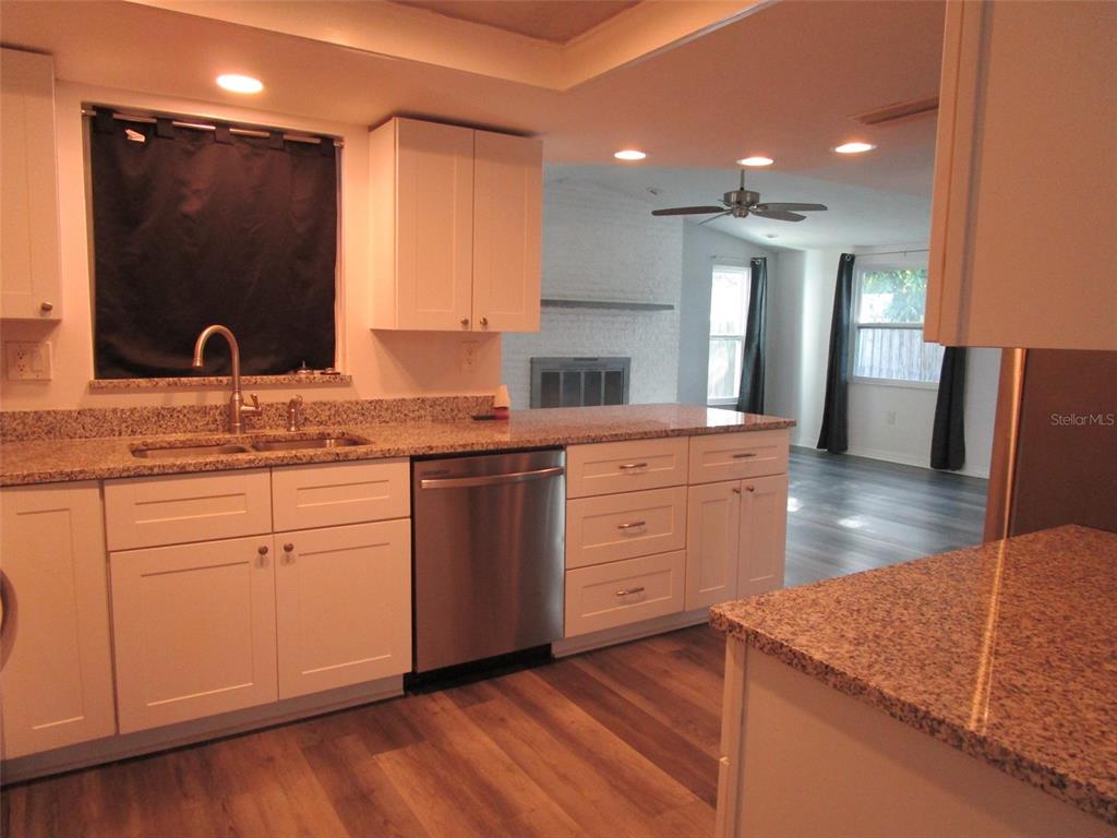 7226 San Moritz Drive Port Richey, FL 34668 - Photo 7 of 38 a kitchen with a sink stove and cabinets