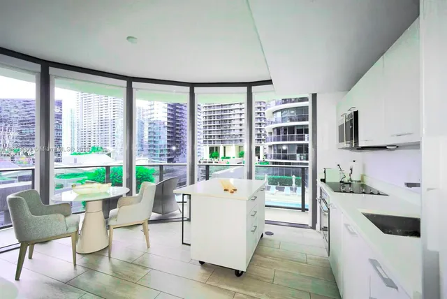 a living room with furniture and large windows