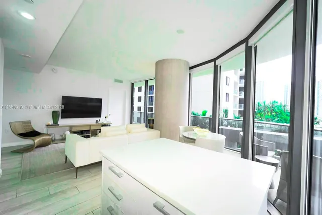 a bedroom with a bed and large windows