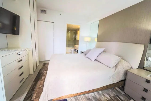 a bedroom with a bed and a cabinets