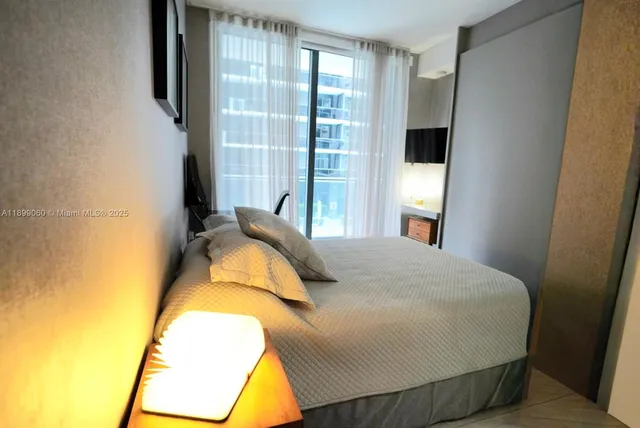 a bedroom with a bed and a window