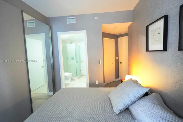 a bathroom with a tub and a glass door shower