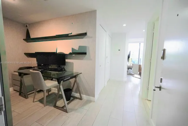 a view of a room with wooden floor and furniture