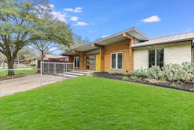 a front view of house with yard and green space