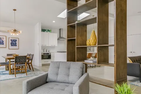a living room with furniture a dining table and chairs