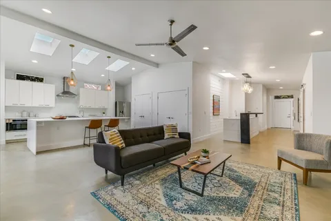 a living room with furniture and kitchen view