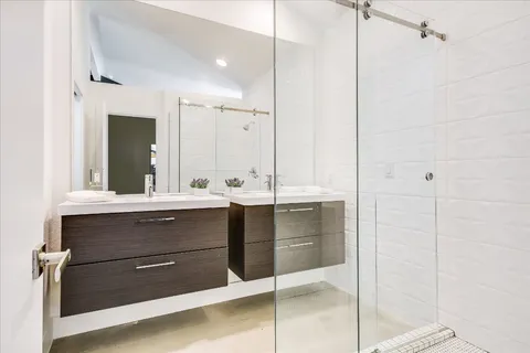 a bathroom with a sink vanity and mirror