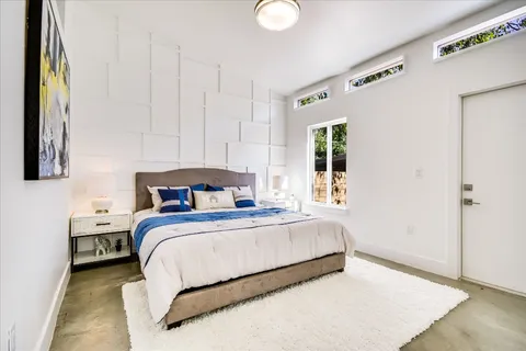 a bedroom with a bed and a window