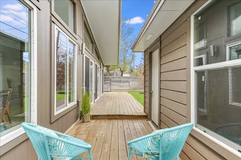 a view of balcony with two chairs and wooden floor