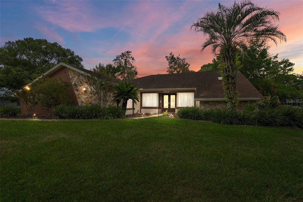 a front view of a house with a garden