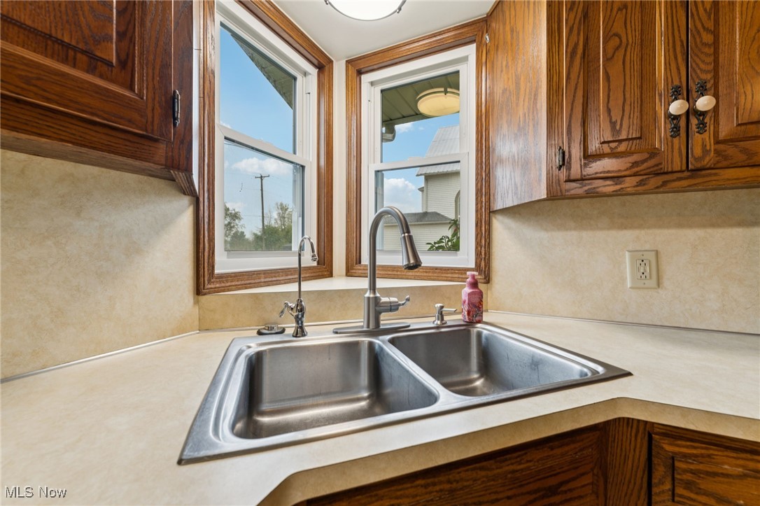 12422 Portage Street Rittman, OH 44270 - Photo 13 of 42 Kitchen featuring light countertops and brown cabinetry
