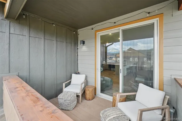 a kitchen with stainless steel appliances kitchen island granite countertop a dining table chairs and a refrigerator