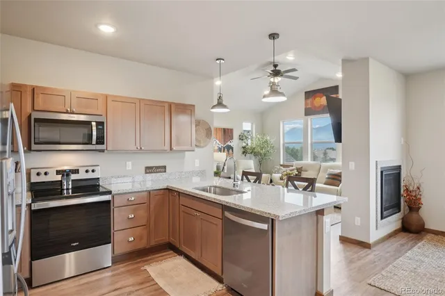 a kitchen with granite countertop a large window cabinets and stainless steel appliances