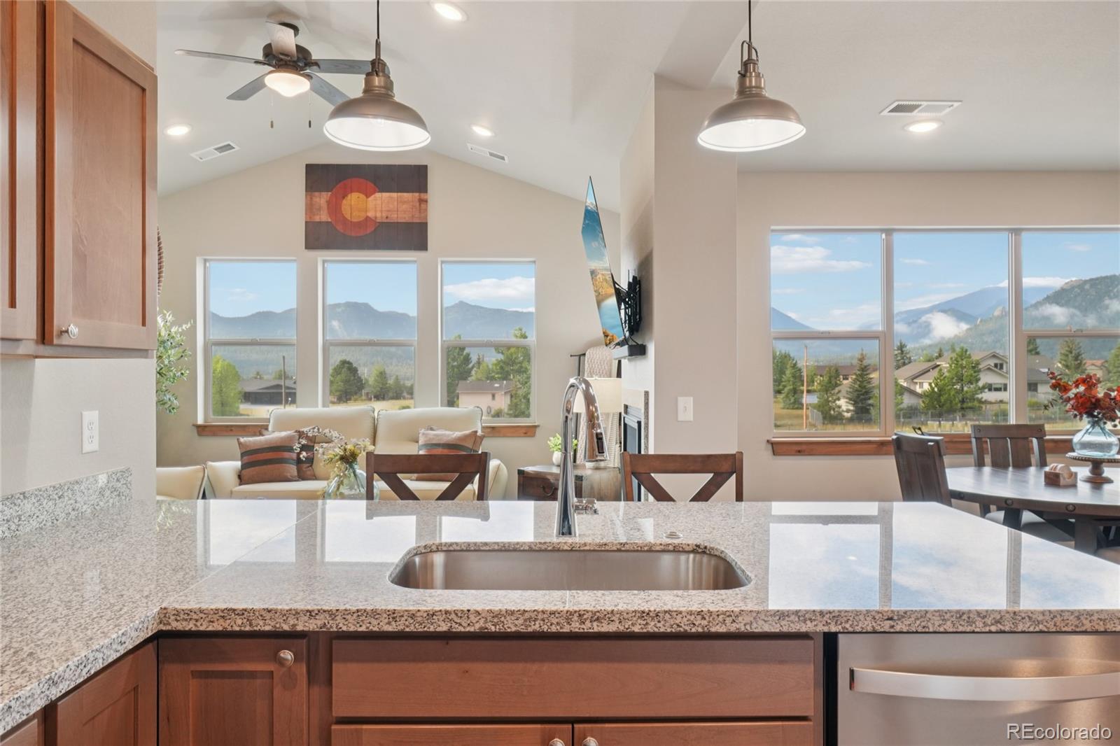 1700 Wildfire Road, Unit 301 Estes Park, CO 80517 - Photo 17 of 38 a kitchen with granite countertop a large window cabinets and stainless steel appliances