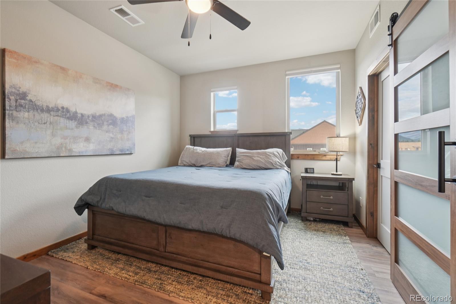 1700 Wildfire Road, Unit 301 Estes Park, CO 80517 - Photo 19 of 38 a bedroom with a bed and a painting on the wall