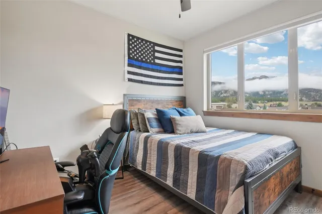 a bedroom with a bed and a painting on the wall