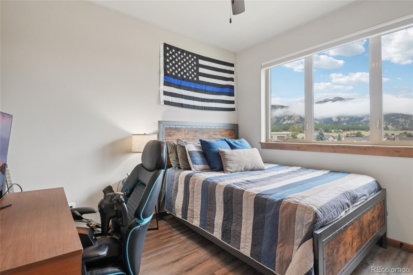 1700 Wildfire Road, Unit 301 Estes Park, CO 80517 - Photo 23 of 38 a bedroom with a bed and wooden floor