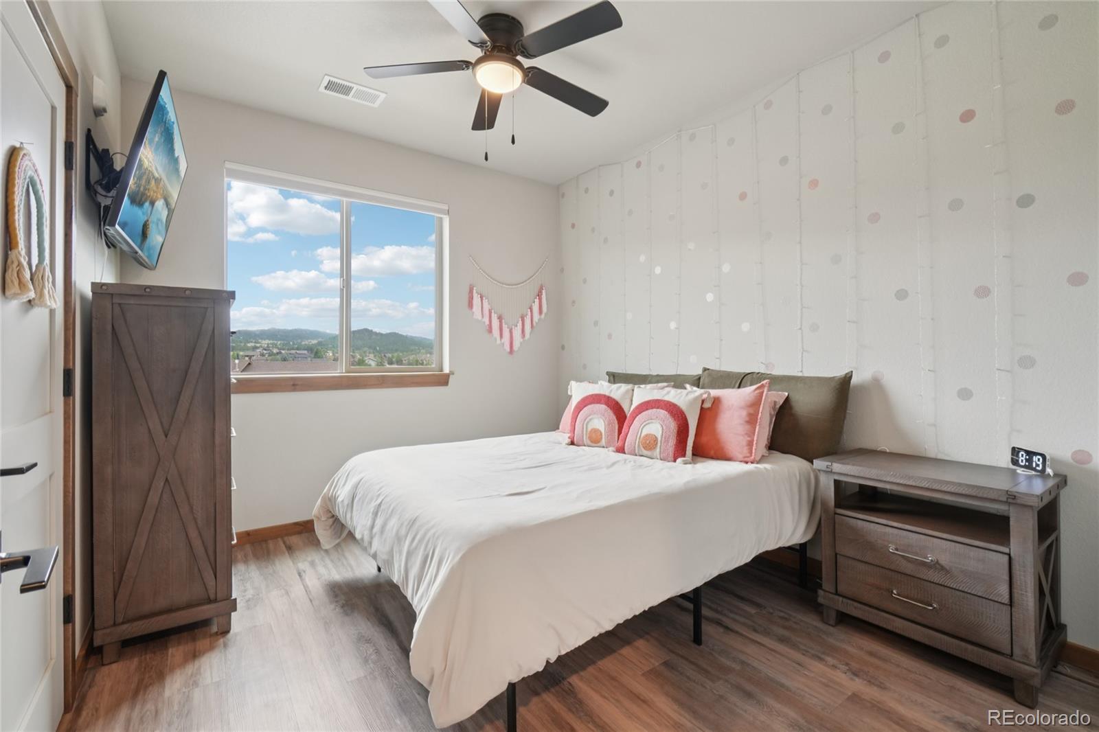 1700 Wildfire Road, Unit 301 Estes Park, CO 80517 - Photo 25 of 38 a bedroom with a bed and wooden floor