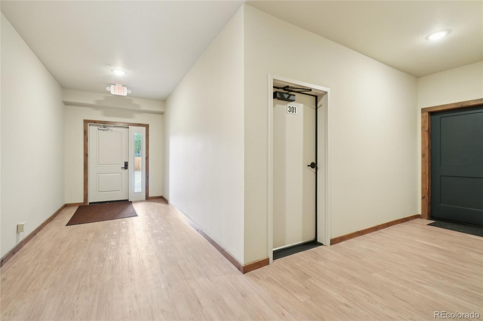1700 Wildfire Road, Unit 301 Estes Park, CO 80517 - Photo 28 of 38 a view of a hallway with wooden floor and a bathroom