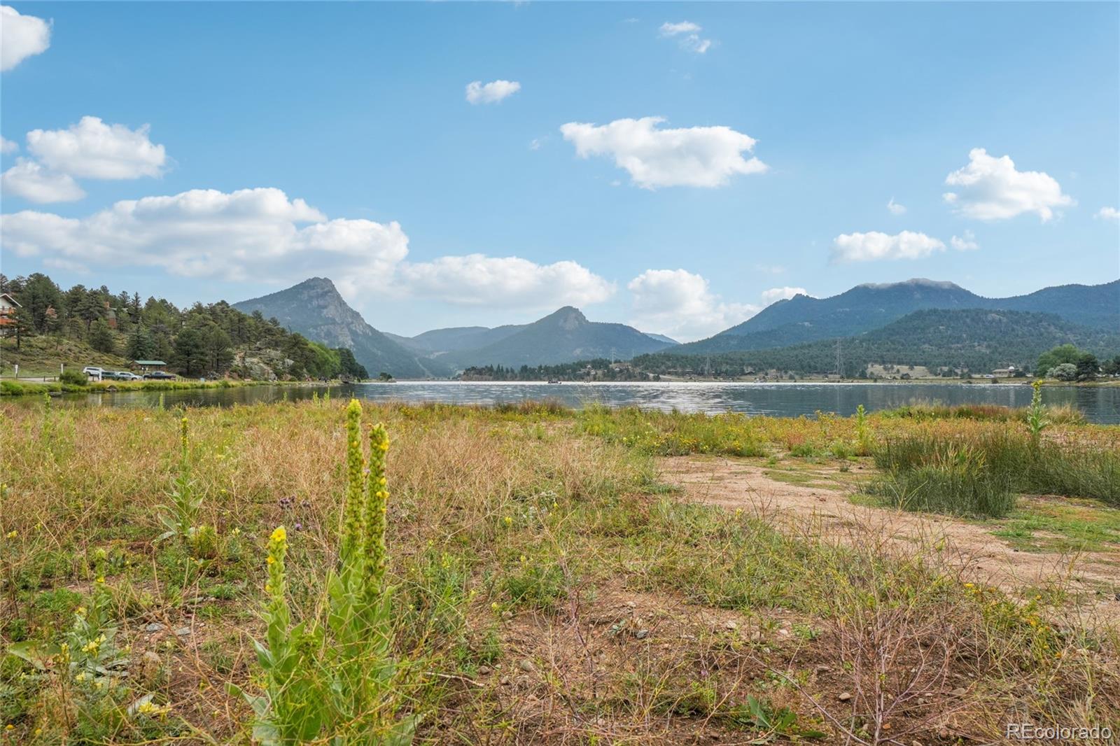 1700 Wildfire Road, Unit 301 Estes Park, CO 80517 - Photo 37 of 38 a view of a lake with sunset in the background