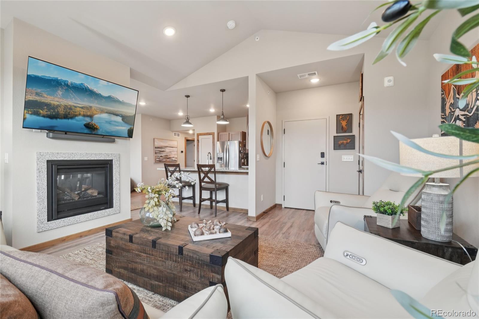 1700 Wildfire Road, Unit 301 Estes Park, CO 80517 - Photo 7 of 38 a living room with furniture and a fireplace