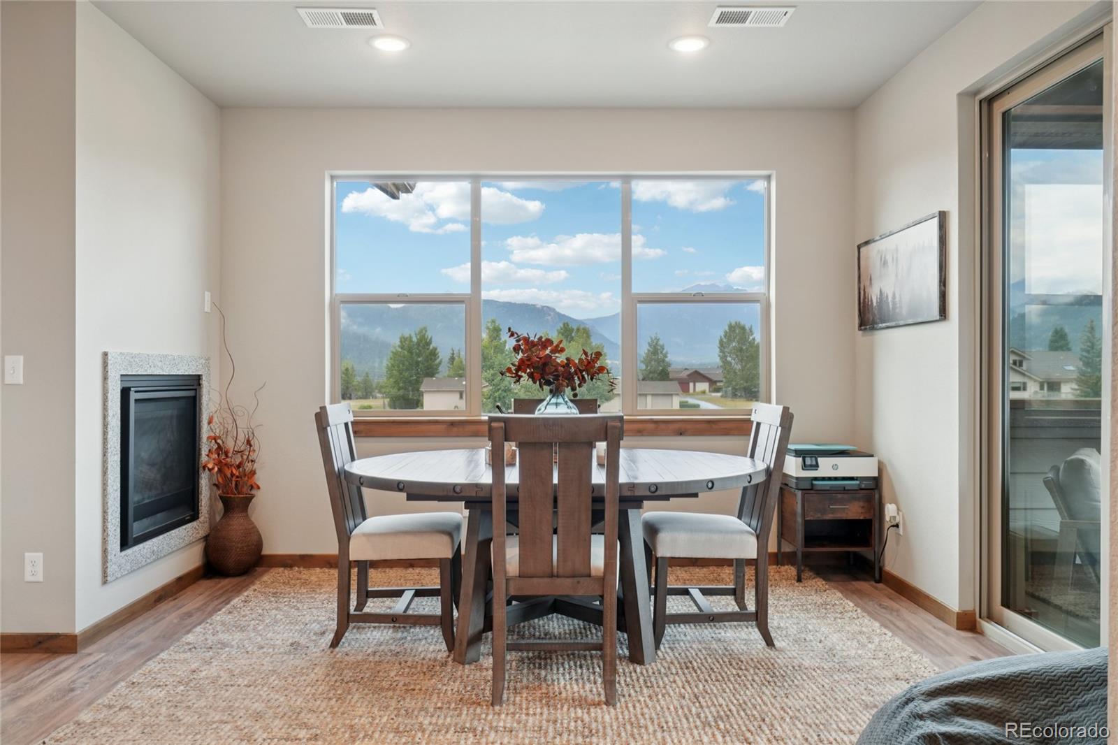 1700 Wildfire Road, Unit 301 Estes Park, CO 80517 - Photo 10 of 38 a dining room with furniture and a floor to ceiling window