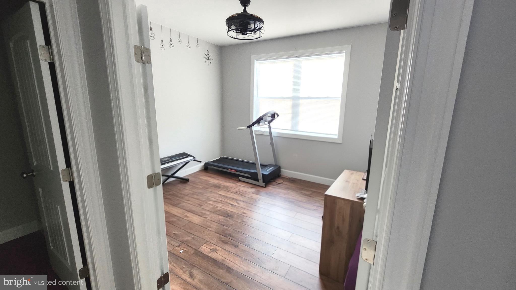 2510 Somerset Road Chambersburg, PA 17202 - Photo 12 of 32 a view of a room with a mirror and wooden floor