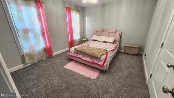 a bedroom with a bed and a mirror