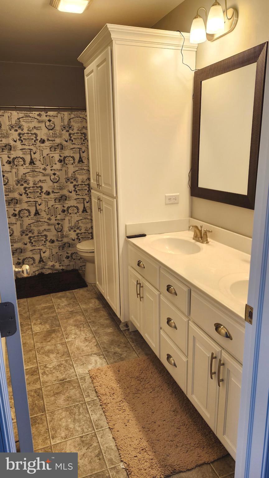 2510 Somerset Road Chambersburg, PA 17202 - Photo 21 of 32 a bathroom with a granite countertop sink a mirror and shower