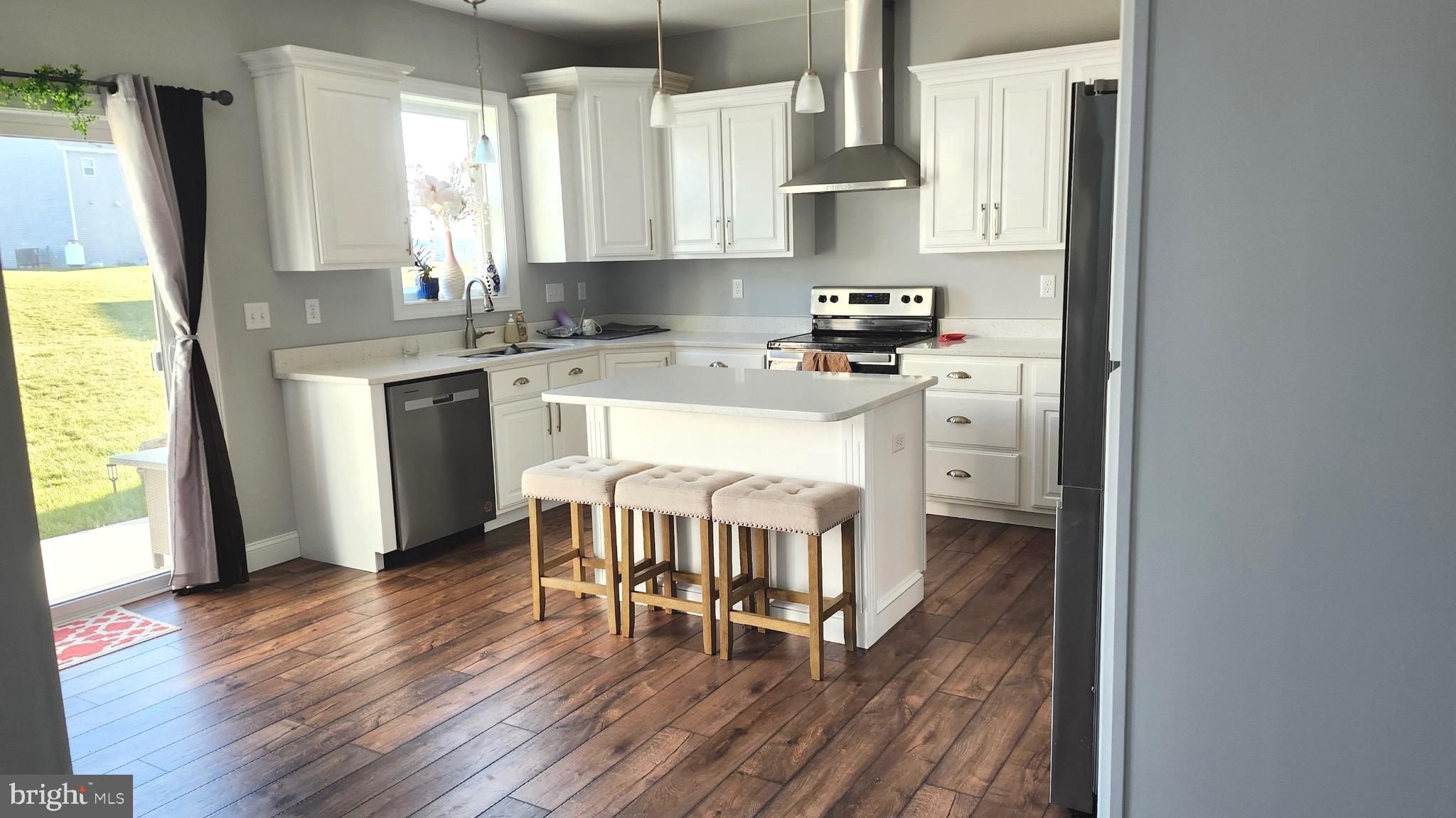 2510 Somerset Road Chambersburg, PA 17202 - Photo 5 of 32 a kitchen with stainless steel appliances a dining table chairs a refrigerator and a sink
