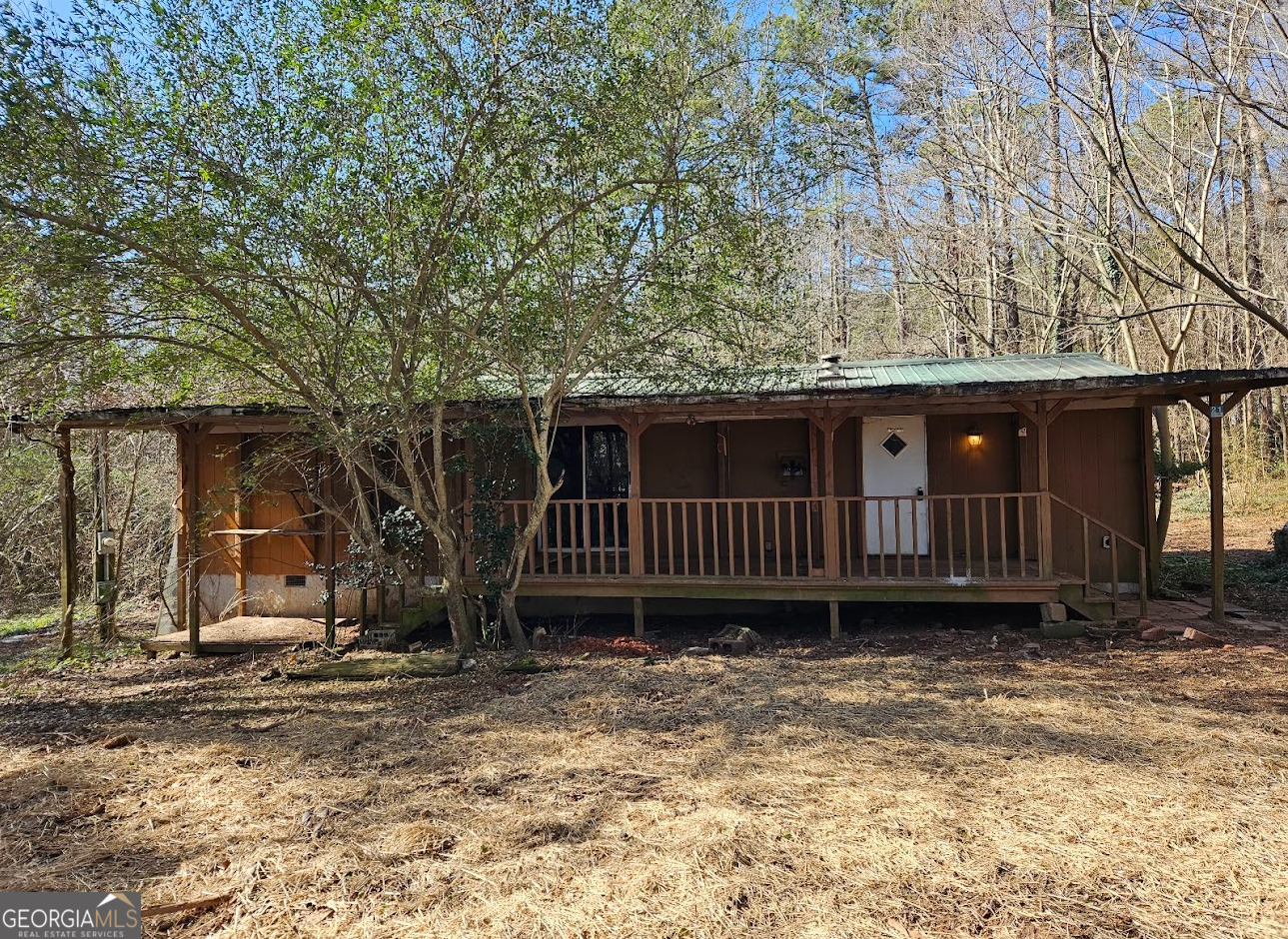 1810 Sandy Flat Road Bowdon, GA 30108 - Photo 2 of 30 a view of a house with a yard and wooden fence